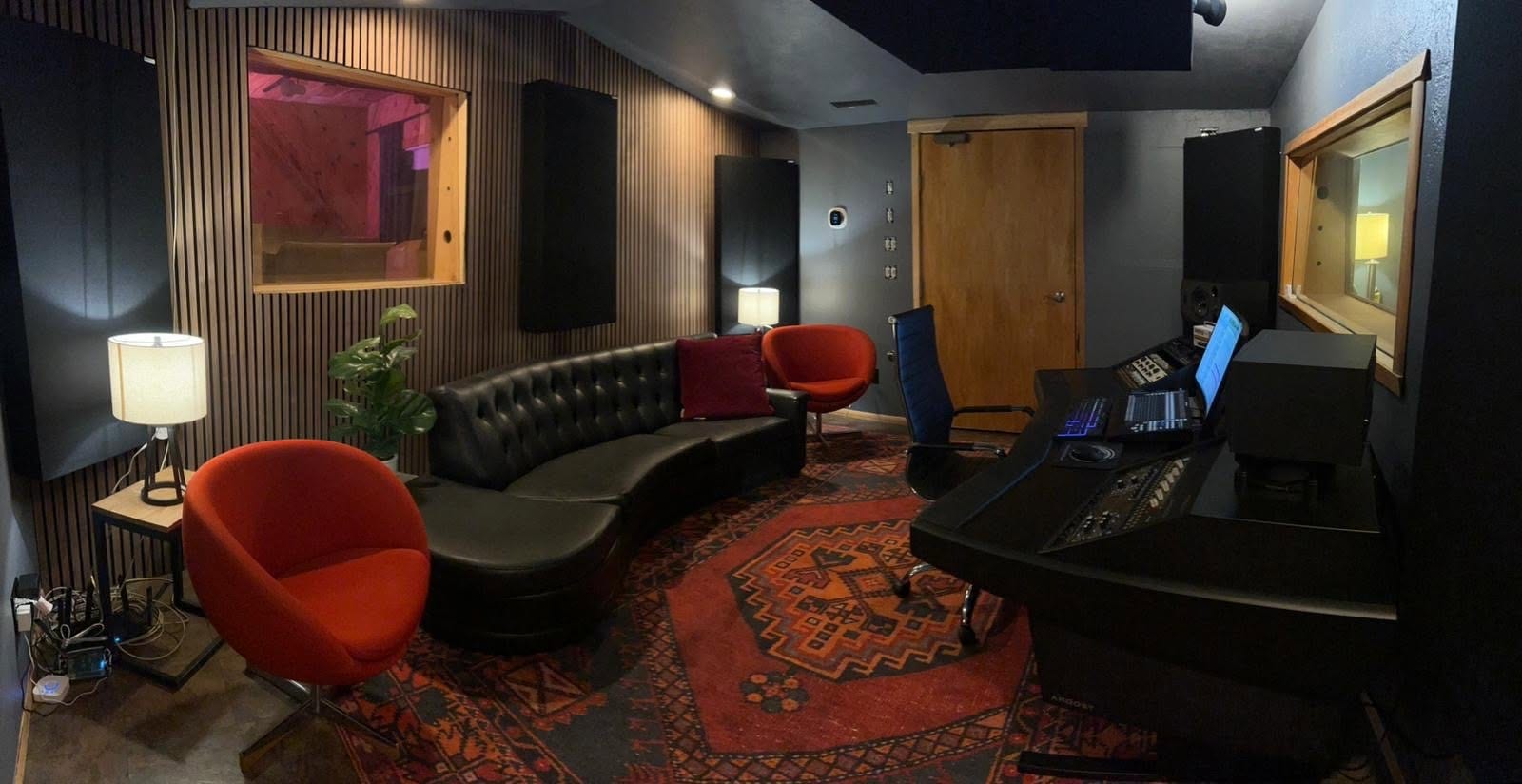 Control room with red chairs and wood-slat walls