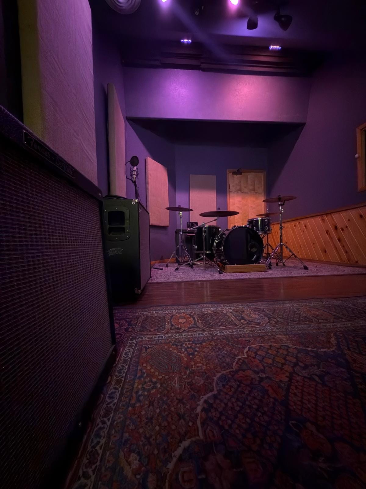 Live room with drum kit and amps